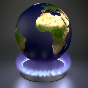 Global warming illustrated by Earth above a gas hob. 